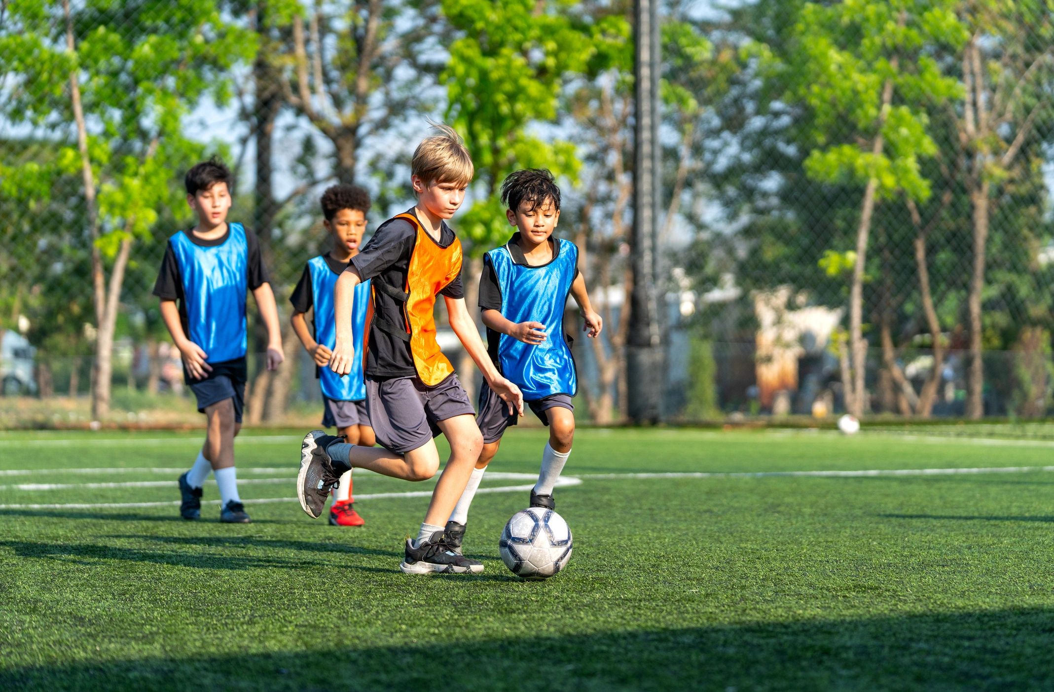 Young soccer player dribbling during outdoor practice